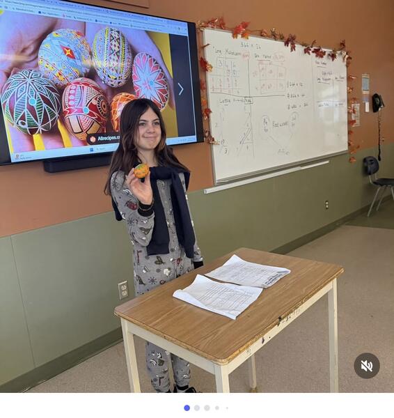 EW, a proud Abby Middle Student, showing off her cultural artifact presentation.