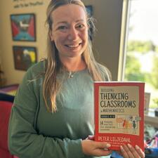 Staff member holds up a book titled "Thinking Classrooms"